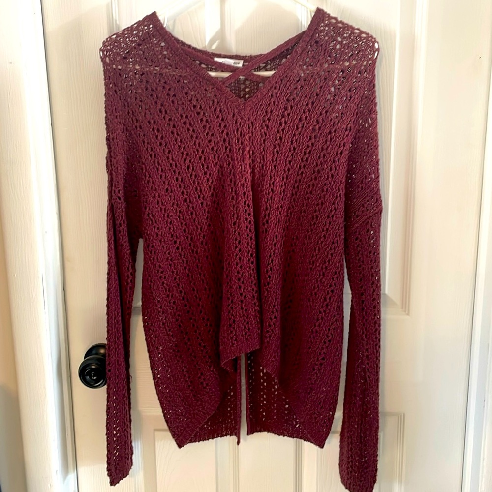 A maroon V-neck sweater by Eyeshadow